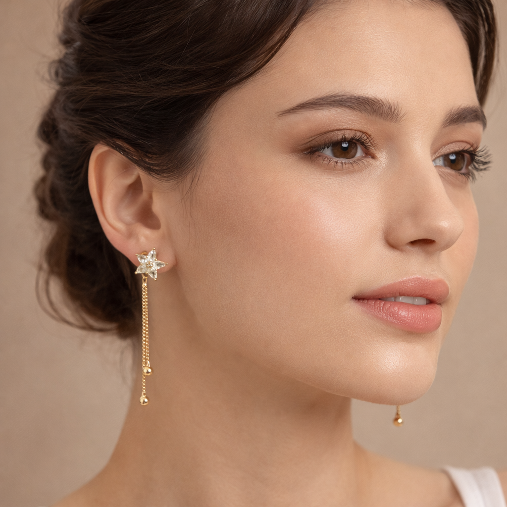 Rose gold star earrings worn by a woman styled for a minimal everyday look