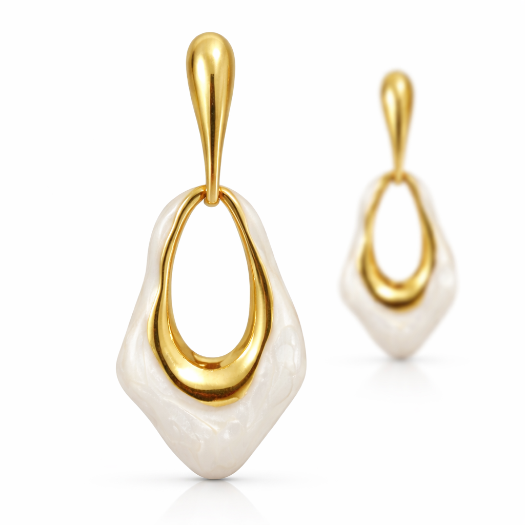 Gold and white earrings on a white background