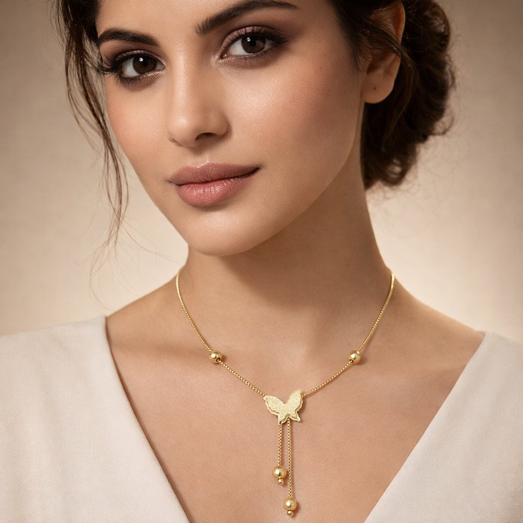 Woman wearing a gold necklace with a butterfly pendant on a beige background