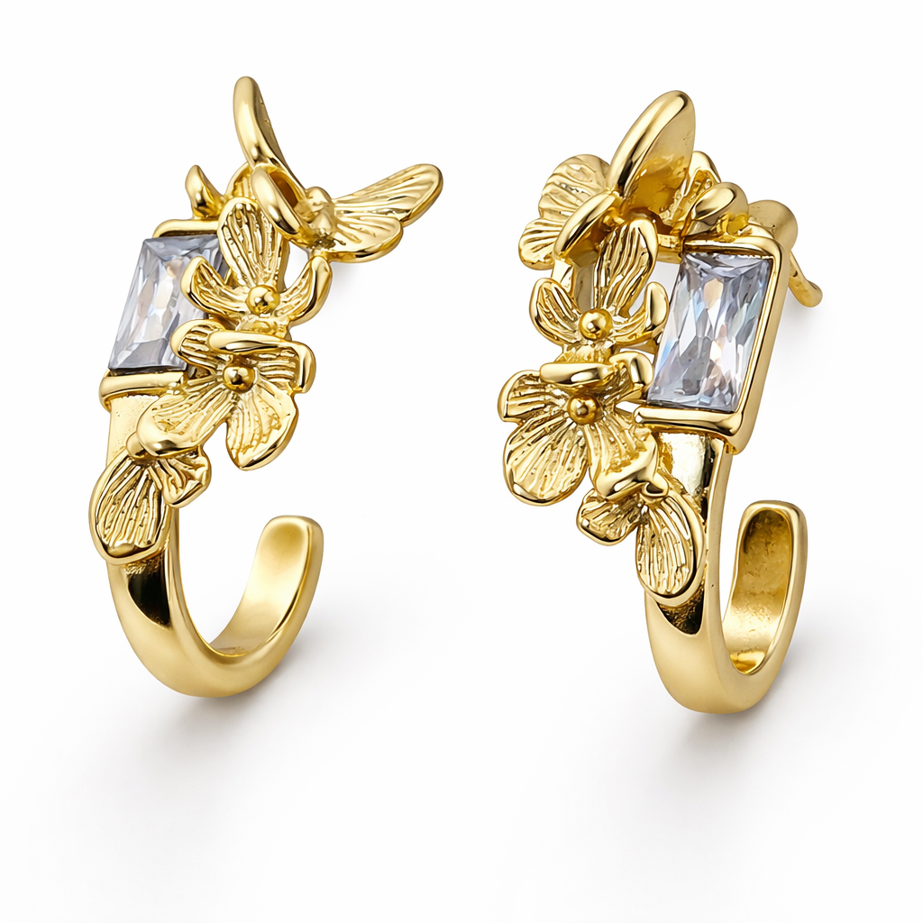 Close-up of gold plated crystal stud earrings highlighting crystal setting prongs and smooth metal finish