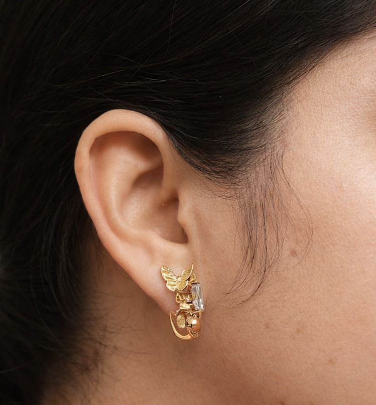 Gold plated crystal stud earrings worn by a woman styled for an elegant everyday look