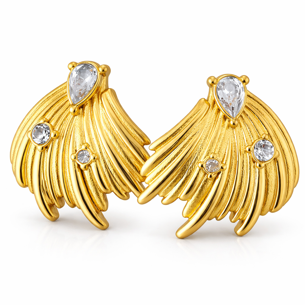 Close-up of feather inspired gold plated earrings highlighting textured design edges and smooth metal finish