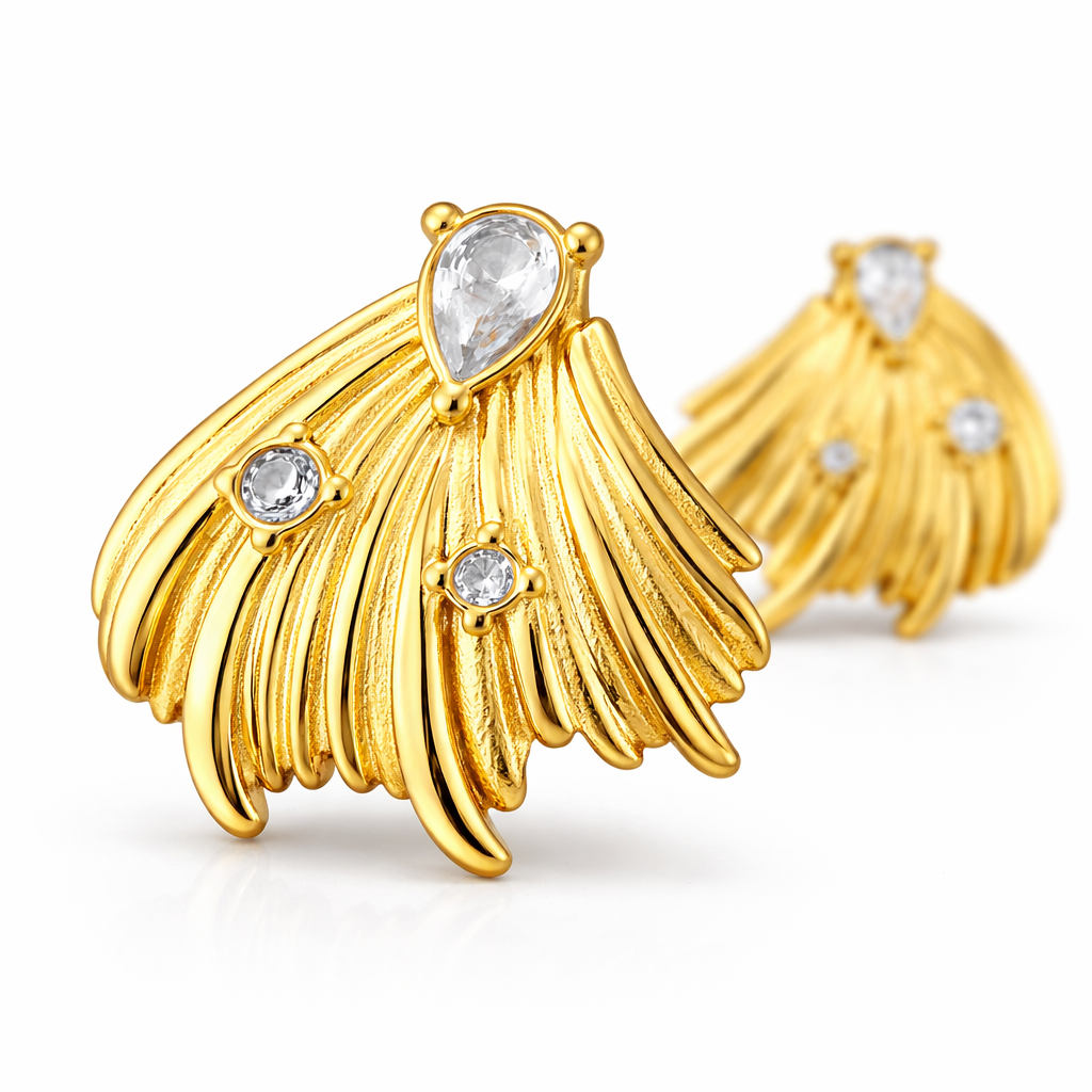Feather inspired gold plated earrings with front earring in sharp focus and second softly blurred