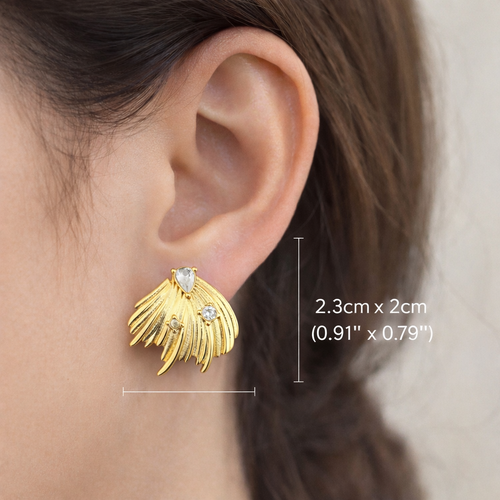 Gold plated feather inspired earrings worn by a woman in a minimal everyday lifestyle setting