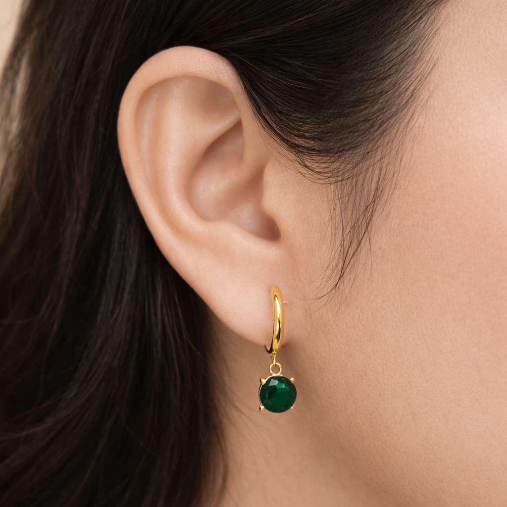 Gold plated hoop circular earrings worn by a woman styled for an everyday minimal look