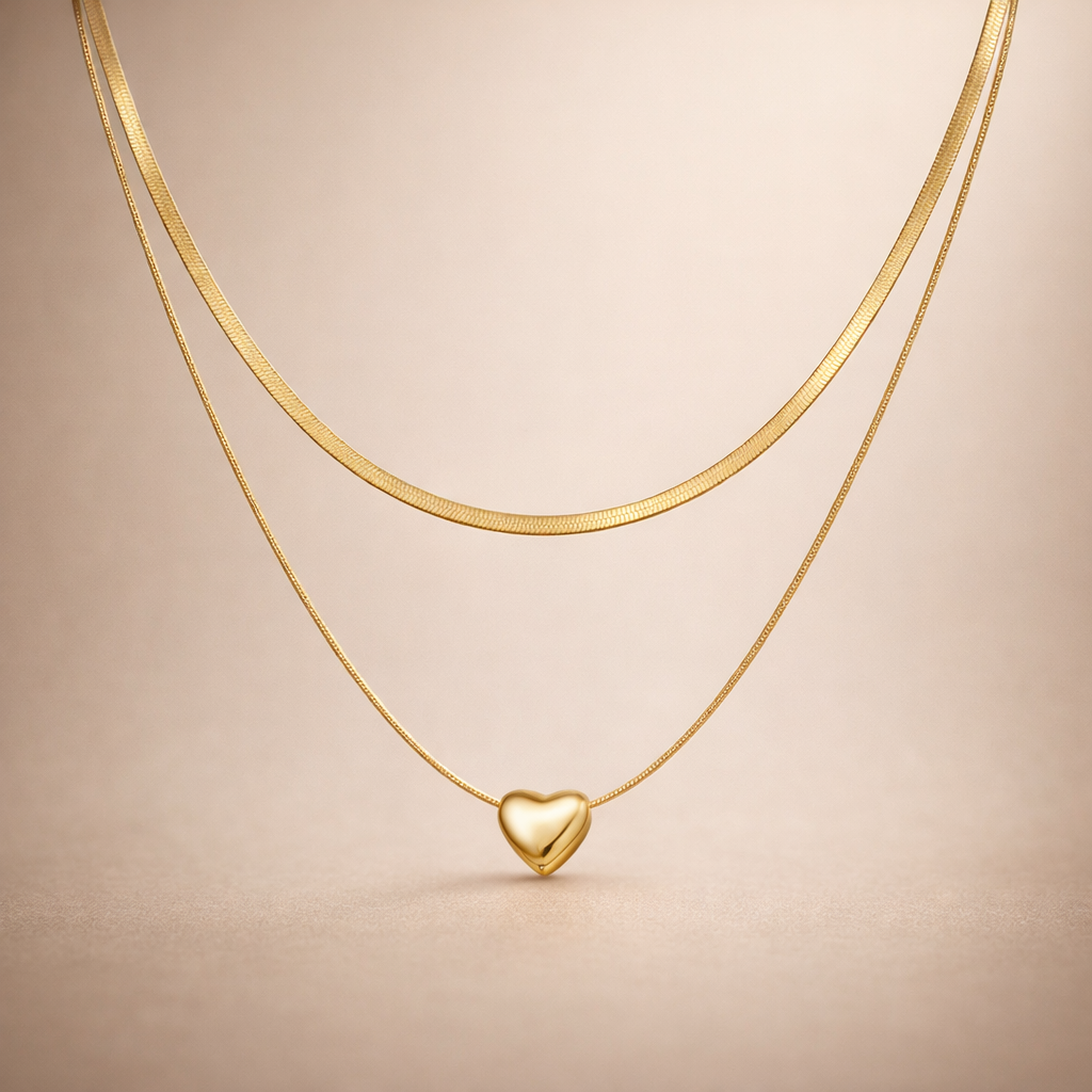Gold heart-shaped pendant necklace on a beige background