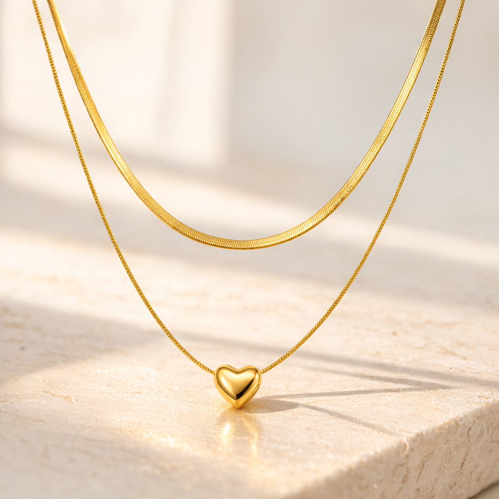 Gold heart-shaped pendant necklace on a light wooden surface