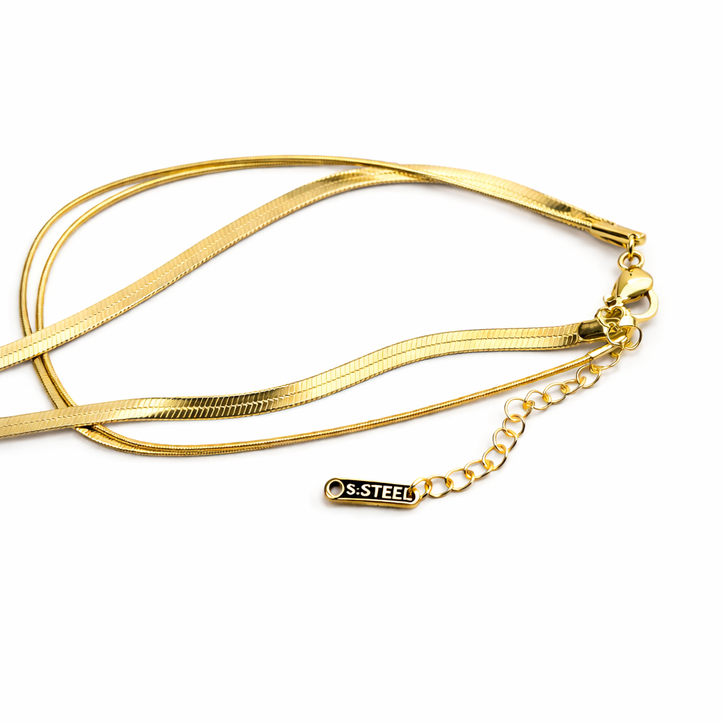 Gold bracelet with a chain extension on a white background