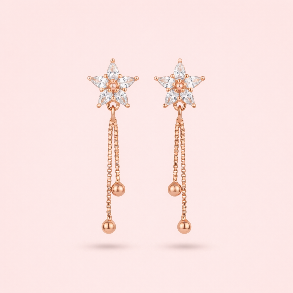 Gold plated rose gold star earrings for women shown as a single product on Soft Blush background