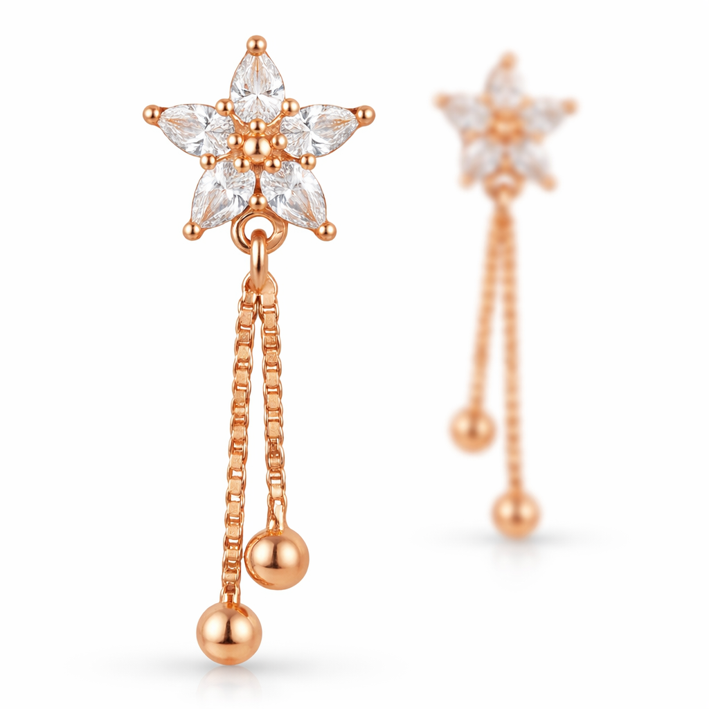 Rose gold star earrings with one earring in sharp focus and second softly blurred behind
