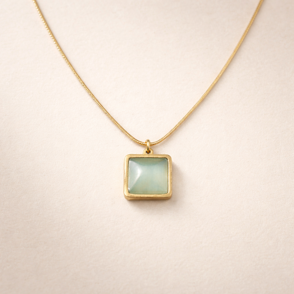 Necklace with a square pendant on a beige background