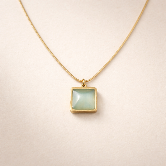Necklace with a square pendant on a beige background