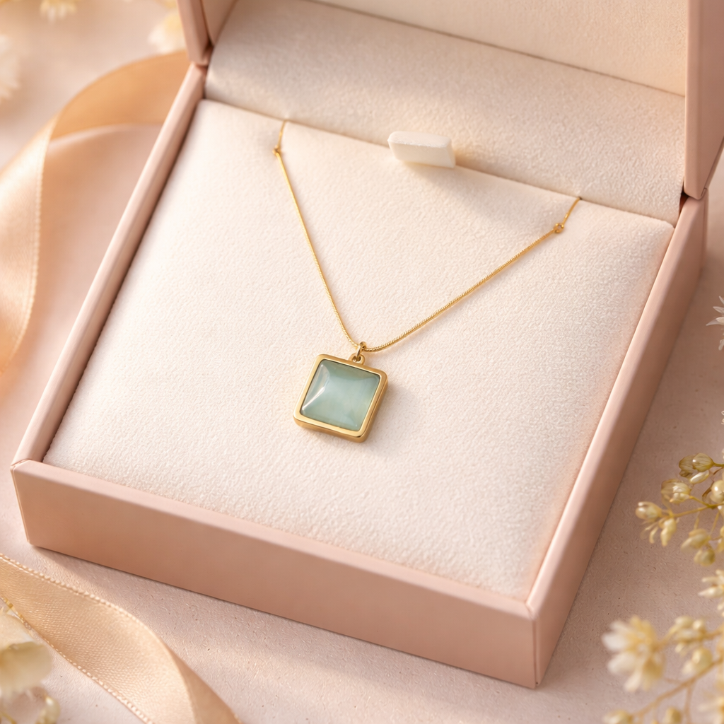Necklace with a square pendant in a pink jewelry box on a soft background