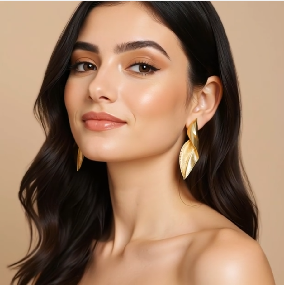 Woman wearing gold earrings against a beige background