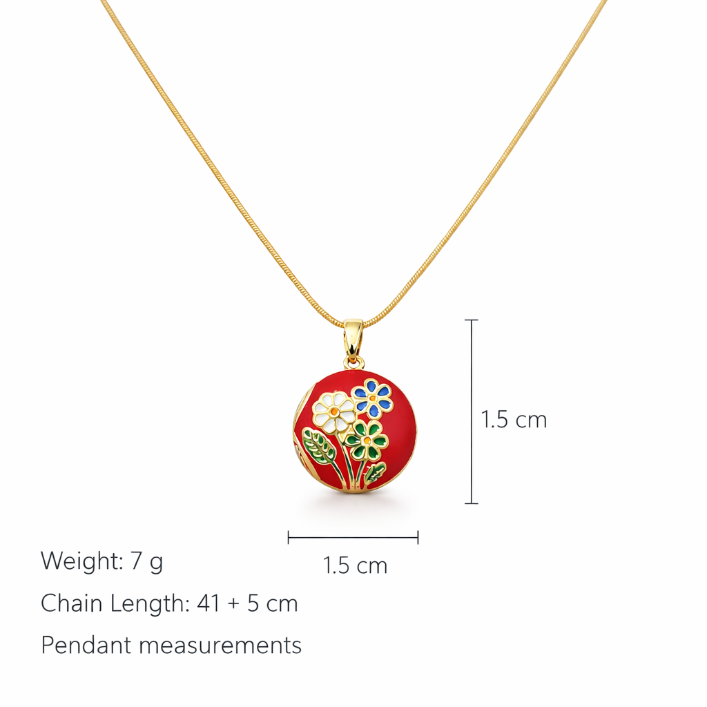 Gold necklace with a red pendant featuring floral designs on a white background