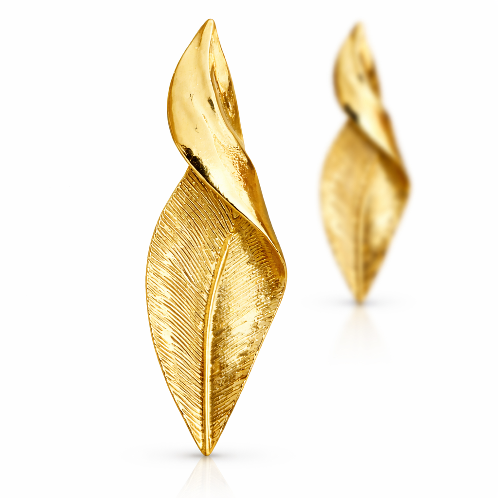Gold leaf-shaped earrings on a white background